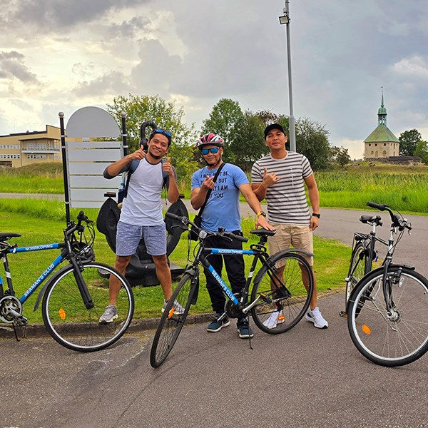 Three guys with loaned bikes ready to go downtown